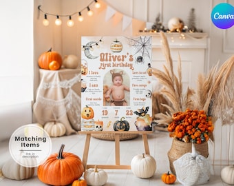 May include: A Halloween-themed first birthday sign on an easel, featuring a baby's photo and stats. The sign is decorated with pumpkins, bats, and a spiderweb. Surrounding the sign are pumpkins and fall decor.