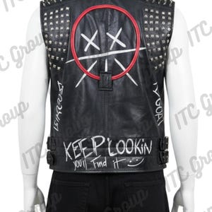 May include: Black leather vest with silver studs and spikes. The back features a white graphic within a red circle, white text, and the phrase "KEEP LOOKIN YOU'LL Find it". The vest has a buckle closure and a collared neckline.