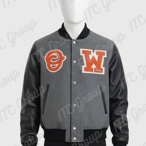 May include: Gray varsity jacket with black leather sleeves. Features orange and white embroidered patches with the letters "O" and "W". The jacket has a black collar, cuffs, and waistband, and a button-up front.