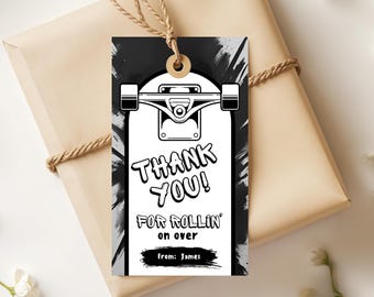 May include: A black and white gift tag featuring a skateboard design with the words "THANK YOU! FOR ROLLIN' on over" in bold, stylized font. The tag includes the text "From: James". The tag is tied to a wrapped gift.