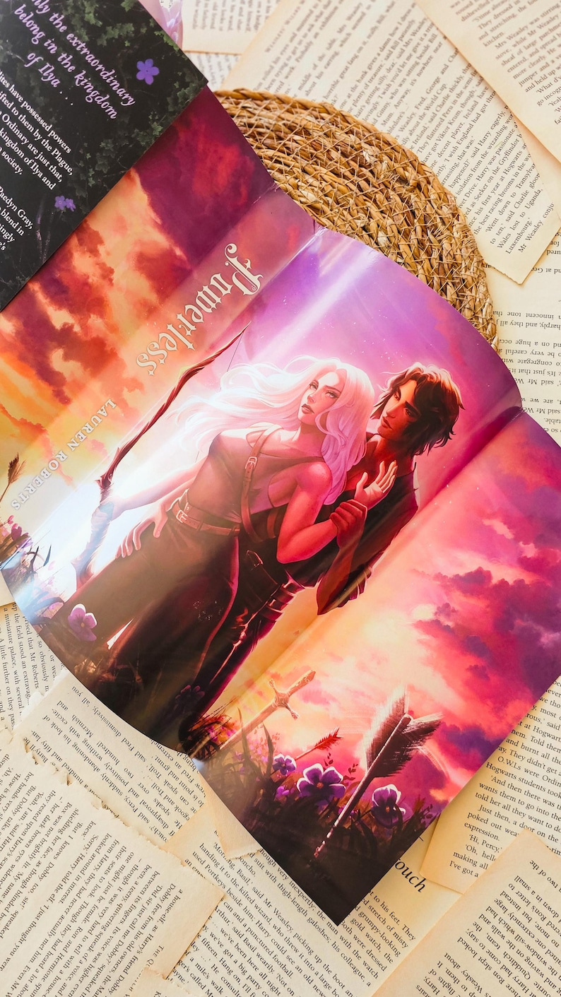 May include: A fantasy novel cover featuring a woman with long blonde hair and a man with dark hair. They are standing in a field with a sunset in the background. The title of the book is "Powerless" and the author is Lauren Roberts.