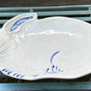 May include: A set of three ceramic mugs with a speckled, matte finish. The mugs are in shades of cream, light brown, and dark brown. Each mug has a simple, minimalist design, perfect for coffee or tea.