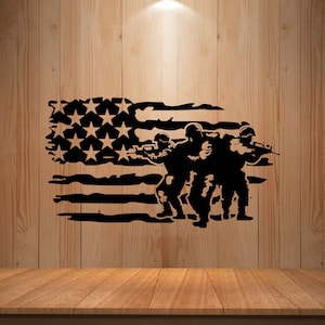 May include: Black silhouette of three soldiers with rifles, positioned in front of a distressed American flag design. The flag features stars and stripes, with a weathered appearance. The image is set against a wooden background.