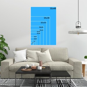 A blue wall mockup displaying vertical aspect ratio sizing guides over a living room sofa.