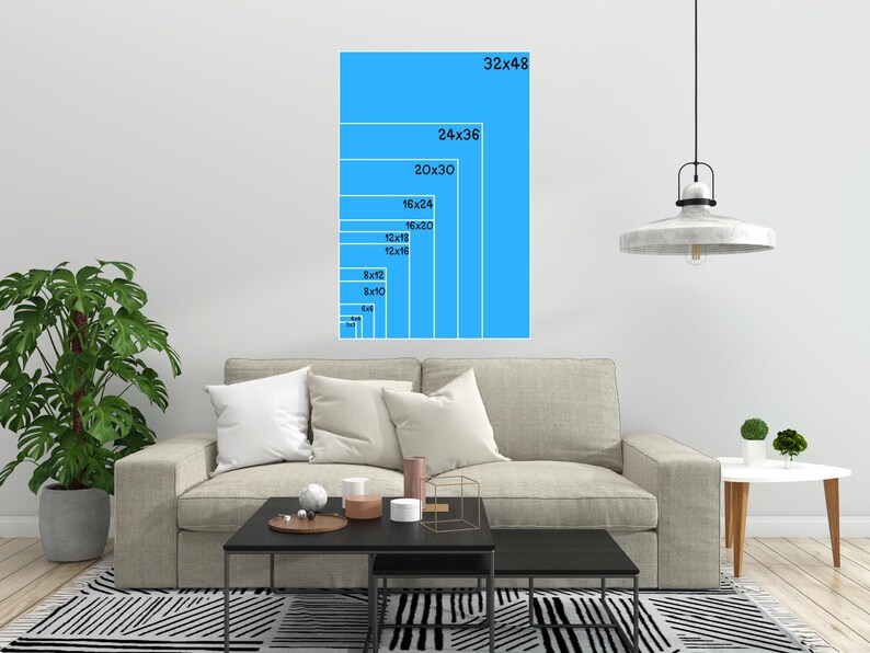 A blue wall mockup displaying vertical aspect ratio sizing guides over a living room sofa.