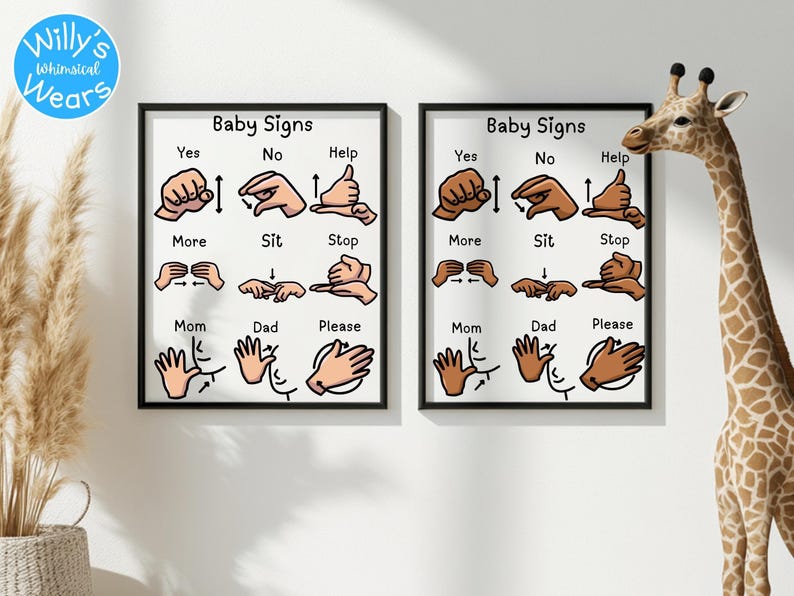 Two framed baby sign language posters hanging on a wall next to a toy giraffe.