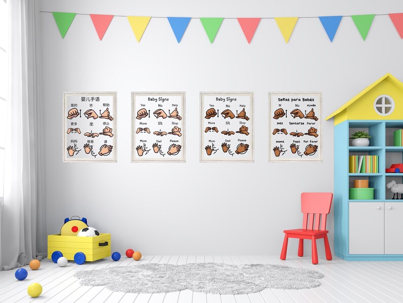 Four framed baby sign language posters hanging on a white wall in a child's playroom with colorful decorations.