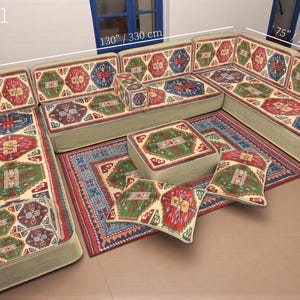 May include: A sectional sofa set with a beige base and colorful patterned cushions and rug. The set includes a corner sofa, ottoman, and throw pillows. The sofa measures 130 inches (330 cm) by 75 inches (190 cm), and the pillows are 28 inches (70 cm). The text "SET-1" is visible.