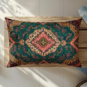 May include: A rectangular throw pillow featuring a deep teal background with a central ornate medallion in shades of pink, cream, and olive green. The design includes intricate floral and vine patterns throughout, with dark brown and gold accents.
