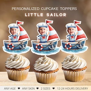 May include: Cupcakes topped with personalized "Little Sailor" themed decorations. Each topper features a baby in a sailor outfit on a boat with a red and white sail. The cupcakes have a swirl of white frosting. Text on the image reads "ANY AGE, ANY SKIN, 2 SIZES, 12-24 HOURS DELIVERY."