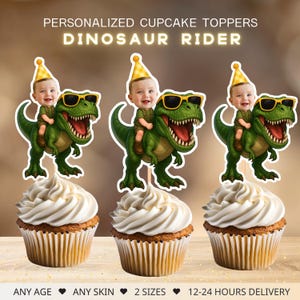 May include: Cupcake toppers featuring a baby riding a green dinosaur with sunglasses. The toppers are personalized and say "Dinosaur Rider". The cupcakes have white frosting and are in brown paper liners. The text at the bottom says "ANY AGE, ANY SKIN, 2 SIZES, 12-24 HOURS DELIVERY".