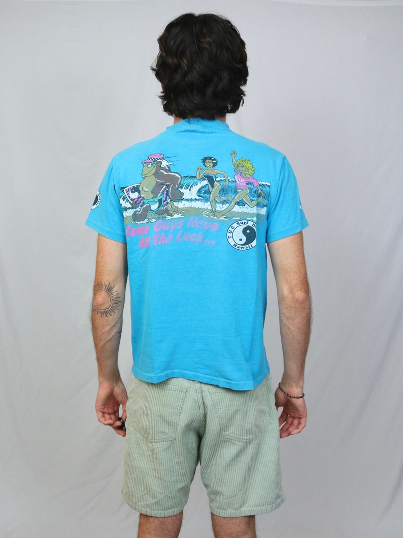 Vintage 80s T&C Surf designs Hawaii t shirt M Hanes Light blue some guys have all the luck thrilla gorilla graphic tee made in USA image 1