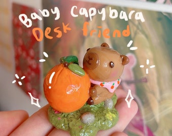 Baby capybara cuddling an orange desk friend | capybara lover desk ornament | special gift for loved ones | adorable desk companion | cute