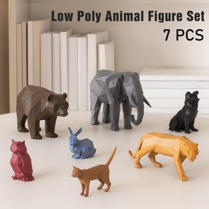 May include: A set of seven low-poly animal figures in various colors, including a bear, elephant, dog, owl, rabbit, cat, and tiger. The figures are geometric and modern, with the text "Low Poly Animal Figure Set 7 PCS" above them.