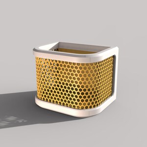 May include: A modern, geometric container with a white frame and a gold honeycomb mesh design. The interior appears to be gold as well. The container has rounded corners and sits on a light gray surface.