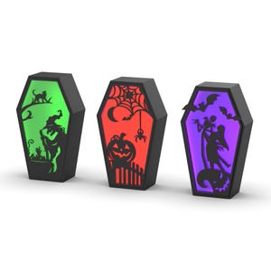 May include: Three black coffin-shaped Halloween decorations with internal lighting. One features a witch silhouette with green light, another a pumpkin with red light, and the last a couple with purple light.