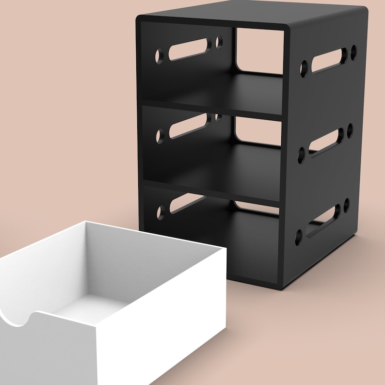 Puede incluir: Una estanter&iacute;a negra de tres niveles con lados abiertos y un caj&oacute;n blanco. La estanter&iacute;a tiene tres estantes y est&aacute; hecha de madera. El caj&oacute;n est&aacute; hecho de pl&aacute;stico.