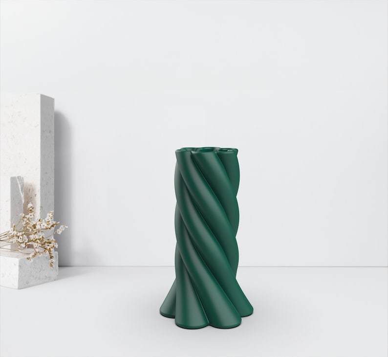 May include: A dark green ceramic vase with a twisted, textured design. The vase has a wide base and a narrow neck.
