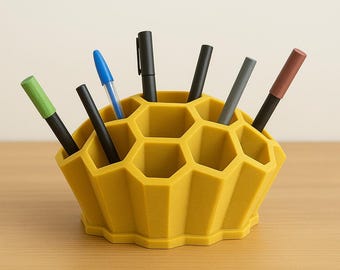 May include: A yellow honeycomb-shaped desk organizer with multiple compartments for pens, pencils, and other office supplies.