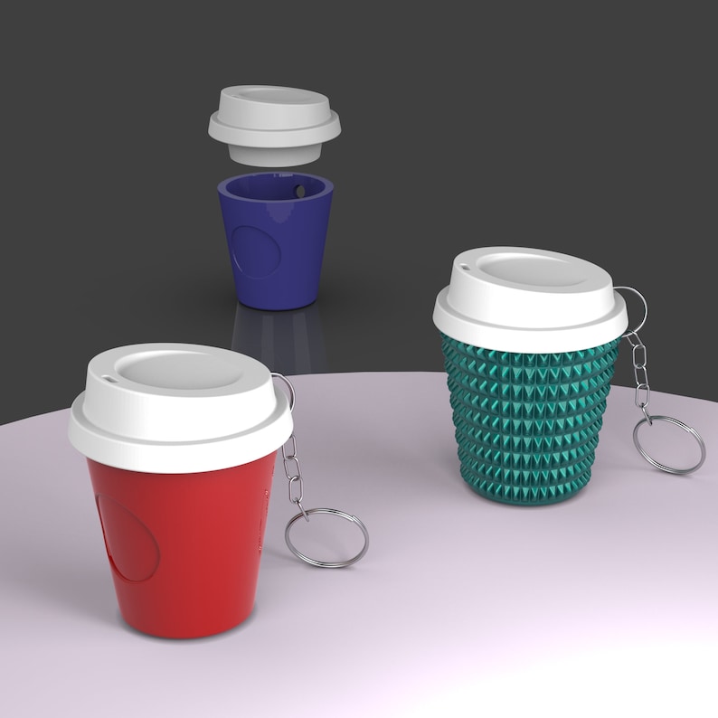 May include: Three different coffee cup keychains. One is red with a white lid, one is blue with a white lid, and one is green with a white lid and a textured design.