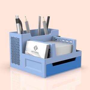 May include: A light blue desktop organizer with a drawer and compartments for pens, pencils, and business cards. The organizer has a label that says "COMPANY NAME".