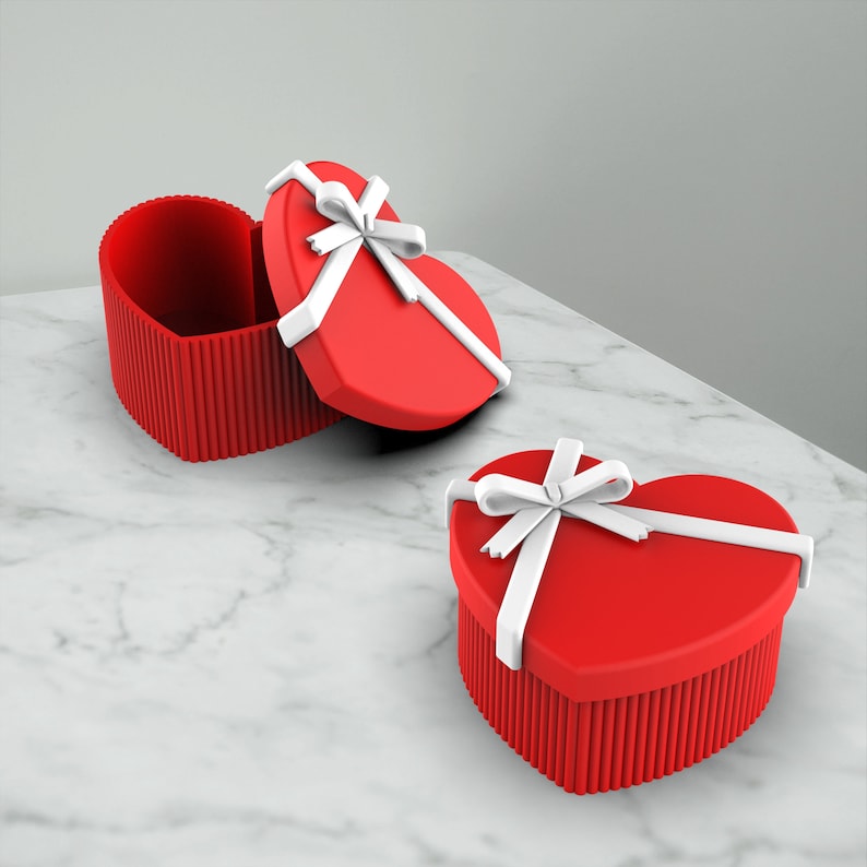 May include: Two red heart-shaped gift boxes with white ribbon bows. The boxes are open and one is lying on its side. Love Heart Box, 3D Valentine’s Gift, Gift - Jewelry - Accessory Box, Organiser Home Decor, Ready to Print, 3D STL File Digital Download