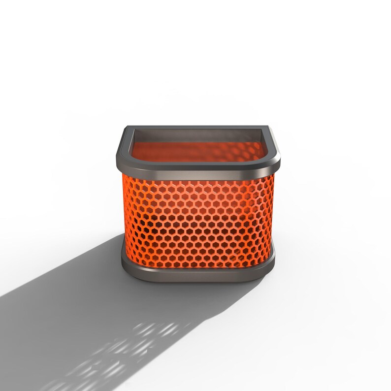 May include: A square air filter with a honeycomb pattern in bright orange. The filter is encased in a dark gray frame with rounded corners. The object casts a shadow on a white background.