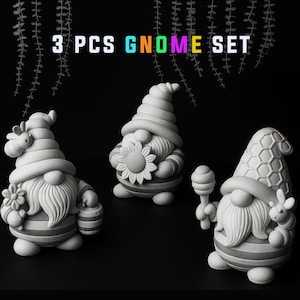 May include: A set of three unpainted gnome figurines. Each gnome has a long white beard, striped clothing, and a tall hat. One gnome holds a flower, another a sunflower, and the third a honey dipper and a bunny. The text "3 PCS GNOME SET" is at the top.