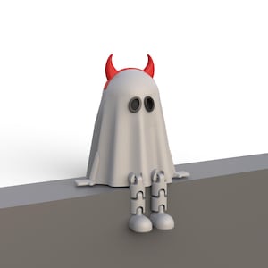 May include: A white ghost figure with black oval eyes and red devil horns. The ghost is sitting with its legs dangling. The figure is a Halloween or spooky-themed decoration.