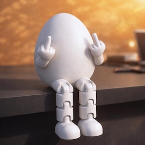 May include: A white egg-shaped figurine with articulated legs and arms, seated on a dark surface. The figurine is giving the middle finger with both hands. The background is blurred, with warm tones.