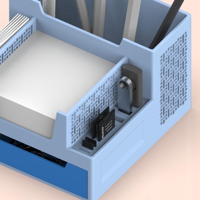 May include: A light blue desk organizer with multiple compartments. The organizer has a drawer, a compartment for notepads, a compartment for pens and pencils, and a compartment for small items like memory cards. The organizer is made of plastic and has a grid pattern on the sides.