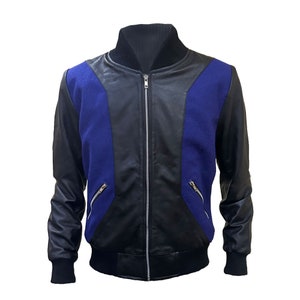 May include: A black and blue bomber jacket with a full-length zipper. The jacket features black leather sleeves and accents, with blue fabric panels on the chest. The collar and cuffs are ribbed black knit. Two zippered pockets are visible.
