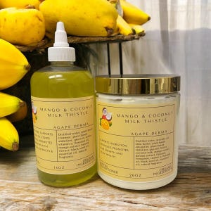 May include: Two bottles of Mango & Coconut Milk Thistle products by Agape Derma. The bottle on the left is a 14 ounce clear glass bottle with a yellow liquid. The bottle on the right is a 20 ounce white plastic jar with a gold lid. Both bottles have a label with the product name and ingredients.