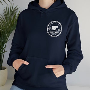 May include: A navy blue hoodie with a white graphic of a polar bear in a circle with the text "Always Cold Club - Freeze Baby -  Frozen"