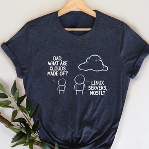 May include: A dark blue t-shirt with a white graphic of a cloud and two stick figures. The text on the shirt reads "Dad, what are clouds made of?" and "Linux servers, mostly."
