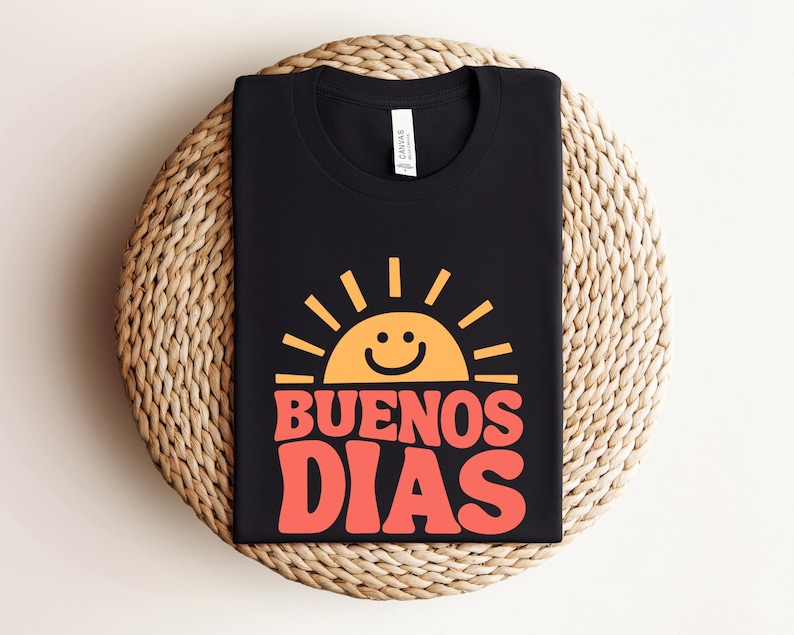 a black t - shirt with the words buenos dias printed on it