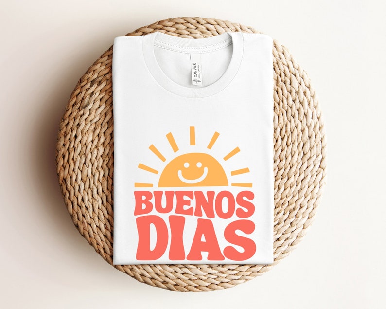 a white t - shirt with the words buenos dias printed on it