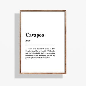 May include: A wooden-framed print featuring the word "Cavapoo" in black. The definition below describes a Cavapoo as a pocket-sized heartthrob, a mix of Cavalier King Charles Spaniel and Poodle, with irresistible fluff.