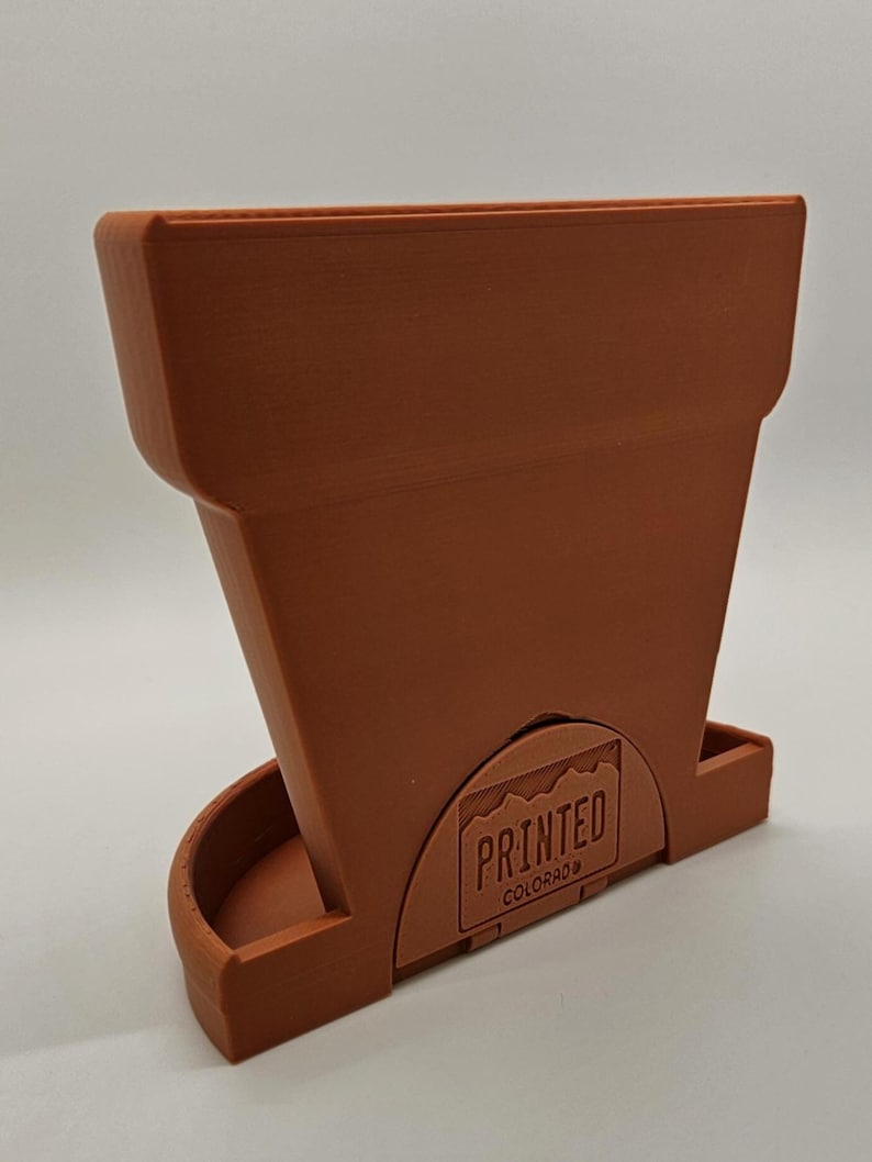 Shown in Red Terracotta with the rear flap up - allowing it to sit flush to a wall, book, etc.