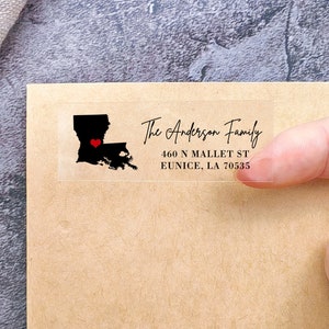 May include: Clear return address label with the text "The Anderson Family", "460 N Mallet St", "Eunice, LA 70535" and a black silhouette of Louisiana with a red heart over the city of Baton Rouge.