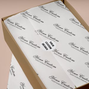 May include: A brown cardboard box with white tissue paper printed with "Your Custom TEXT/LOGO/PHOTO". A white sticker with "YOUR CUSTOM DESIGN" is on the tissue paper. Ideal for packaging and branding.