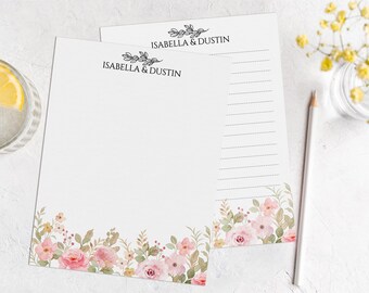 May include: Two white stationery notepads with a floral border and the text "Isabella & Dustin" at the top.