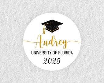 May include: White round sticker with a black graduation cap, gold text that says "Audrey", "University of Florida", and "2025".