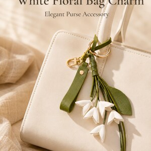 White floral bag charm with leather flowers and gold hardware, elegant purse charm accessory for women, luxury handbag charm with tassel, aesthetic white keychain for tote bag, trendy flower purse accessory, feminine handbag decoration, modern leather floral keychain, gift for her, cute white purse charm, boutique style bag accessory, minimal elegant keychain for handbags, stylish floral charm for purse, luxury fashion bag accessory