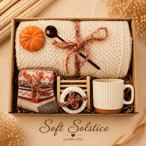 Fall gift box for women, handmade pumpkin soy candle, ceramic mug, artisan soap, decorative glass match bottle, plush teddy bear and cozy autumn socks beautifully arranged in boutique gift packaging. Cozy gift basket and autumn care package perfect as a blanket gift, hygge self care gift, comfort gift, thinking of you gift, appreciation gift, housewarming gift, Thanksgiving hostess gift, birthday gift, get well soon gift and seasonal gift for mom, grandma, sister, friend or coworker.