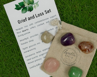 May include: A Grief and Loss Set with a card and a small burlap bag filled with colorful gemstones. The card reads "Grief and Loss Set" with a list of the gemstones and their properties. The gemstones are various colors including pink, green, purple, and brown.