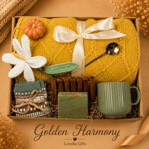 Fall gift box for women, handmade pumpkin soy candle, ceramic mug, artisan soap, decorative glass match bottle, plush teddy bear and cozy autumn socks beautifully arranged in boutique gift packaging. Cozy gift basket and autumn care package perfect as a blanket gift, hygge self care gift, comfort gift, thinking of you gift, appreciation gift, housewarming gift, Thanksgiving hostess gift, birthday gift, get well soon gift and seasonal gift for mom, grandma, sister, friend or coworker.