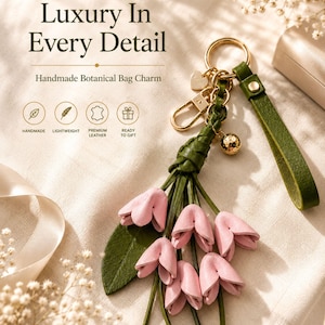 Luxury botanical leather bag charm featuring blush pink leather flowers, olive green leather leaves, decorative tassel, wrist loop, premium gold hardware, and elegant handbag accessory. Handmade floral purse charm designed for luxury handbags, designer inspired totes, shoulder bags, crossbody purses, woven beach bags, and everyday handbags. Arrives beautifully packaged in a signature gift box, making a ready to gift birthday gift, Mother's Day gift, bridesmaid gift, Christmas gift for women.