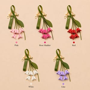 White floral bag charm with leather flowers and gold hardware, elegant purse charm accessory for women, luxury handbag charm with tassel, aesthetic white keychain for tote bag, trendy flower purse accessory, feminine handbag decoration, modern leather floral keychain, gift for her, cute white purse charm, boutique style bag accessory, minimal elegant keychain for handbags, stylish floral charm for purse, luxury fashion bag accessory