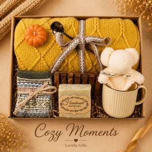 Fall gift box for women, handmade pumpkin soy candle, ceramic mug, artisan soap, decorative glass match bottle, plush teddy bear and cozy autumn socks beautifully arranged in boutique gift packaging. Cozy gift basket and autumn care package perfect as a blanket gift, hygge self care gift, comfort gift, thinking of you gift, appreciation gift, housewarming gift, Thanksgiving hostess gift, birthday gift, get well soon gift and seasonal gift for mom, grandma, sister, friend or coworker.